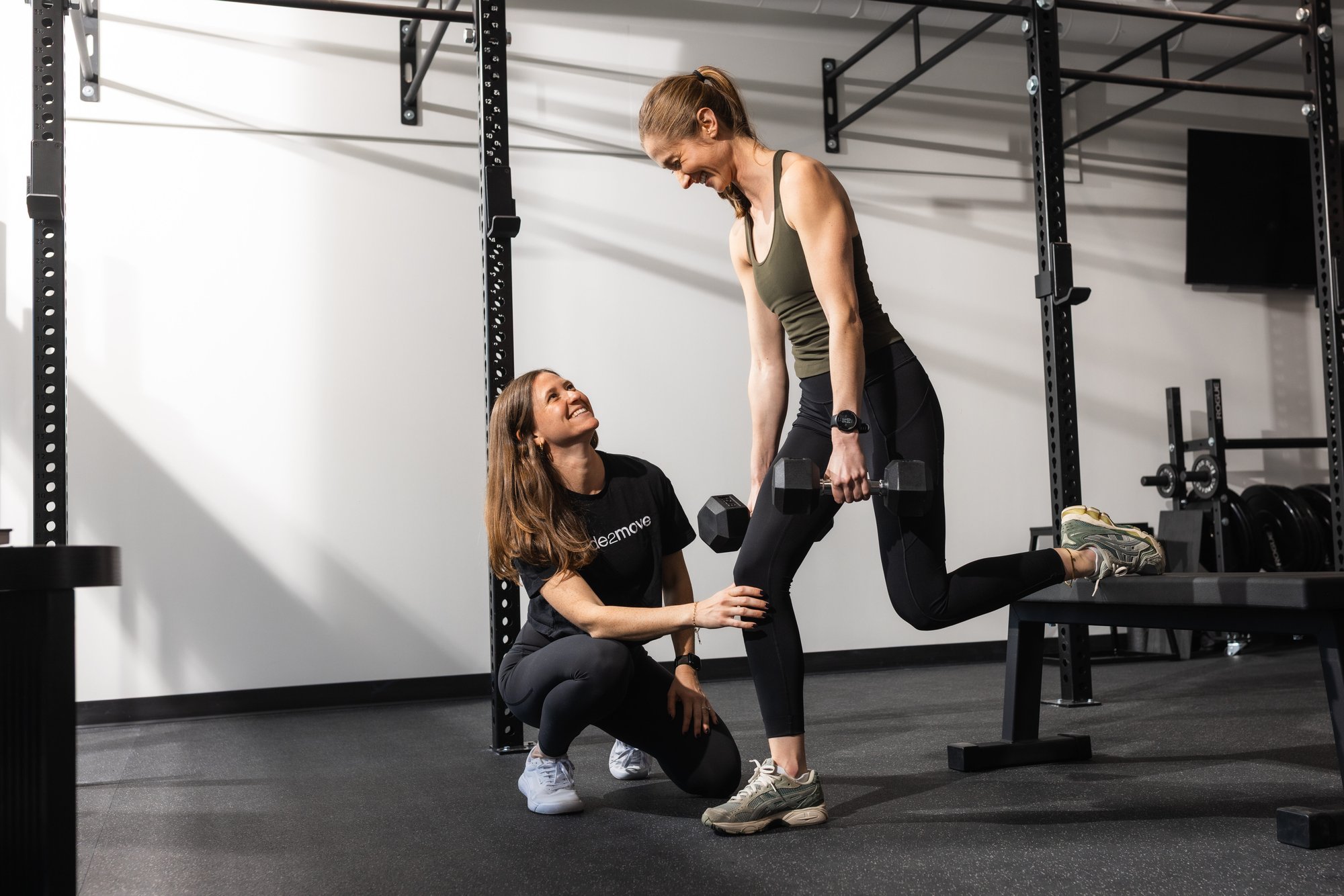 Running injury rehab in Mount Pleasant—PT coaching a patient through functional squat mechanics for performance and pain relief.