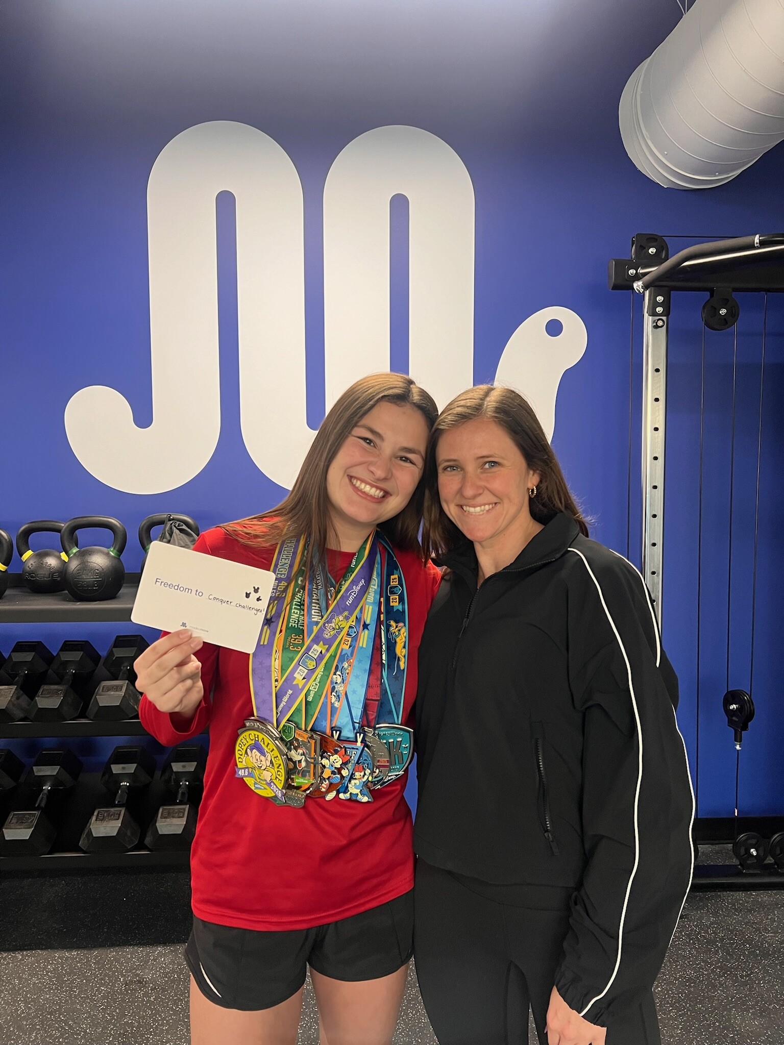 Post-race celebration photo with running physical therapist and patient in Mount Pleasant after personalized rehab and recovery care